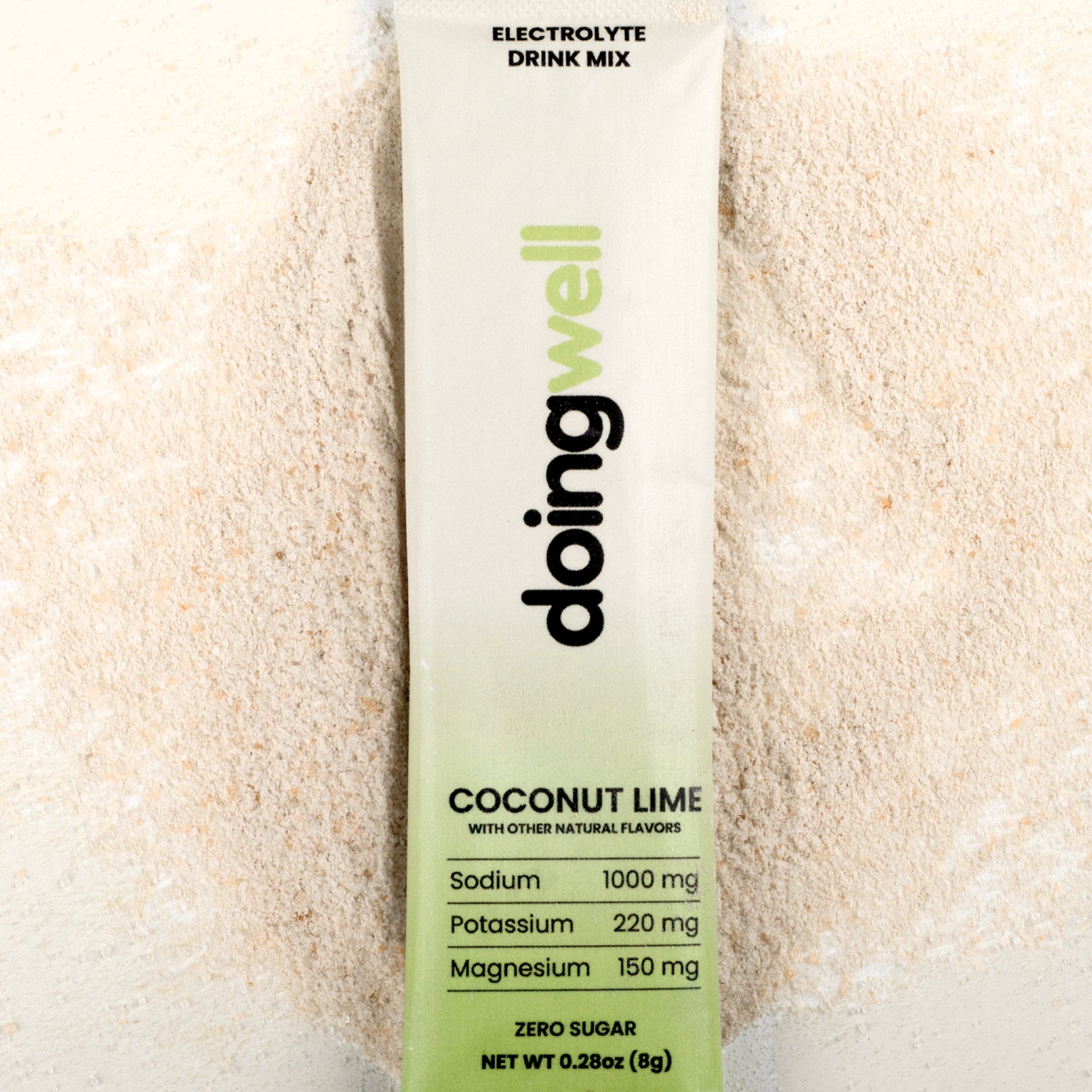 doing well electrolyte drink mix packet with coconut lime flavor on a light background