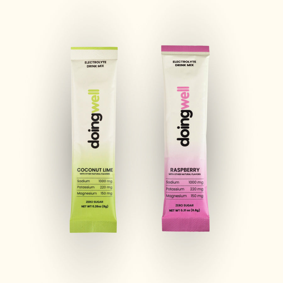 doingwell Electrolyte Sampler Pack — one Coconut Lime and one Raspberry stick pack side by side, 1,000mg sodium each