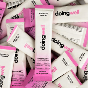 Packs of doing well high sodium electrolyte drink mix in raspberry flavor.