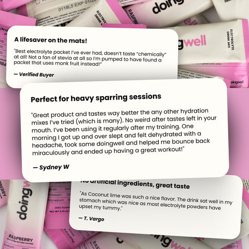 Pink and white electrolyte packets with customer reviews on a pink background